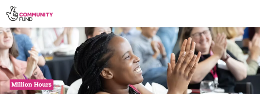 Image of a young black woman smiling and clapping her hands. In the background, there are other people also clapping and smiling. National Lottery Community Fund logo with 'Million Hours' text underneath